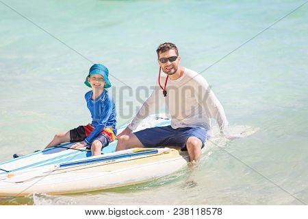 Happy Family Of Two, Father And Son, In Rashguards Enjoying Stand Up Paddleboarding, Healthy Family 