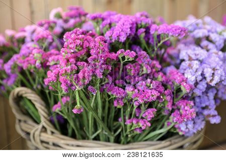 In A Wicker Basket Variety Of Limonium Sinuatum Or Statice Salem Flowers In Pink, Lilac, Violet Colo