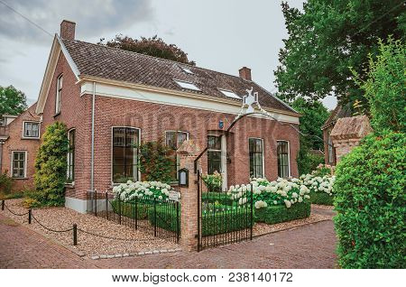 Drimmelen, Southern Netherlands - June 30, 2017. Charming And Quiet Alley With Brick Rustic Houses A