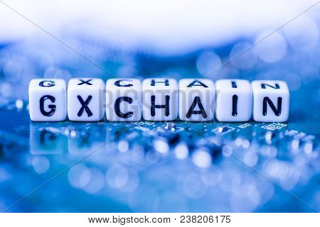 Word Gxchain Formed By Alphabet Blocks On Mother Cryptocurrency Closeup