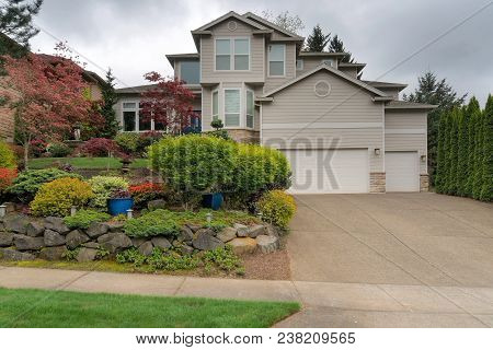 Single Family Home In North American Suburban Neighborhood With Front Yard Garden Landscaping In Spr