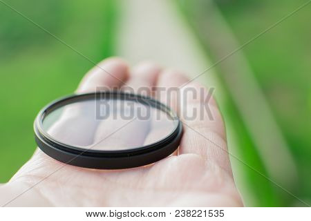 Protective Filter For The Lens Photographer Is Holding A Uv Filter