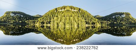 Scenic Reflection Of Forest In The Clear Lake At Bonlieu