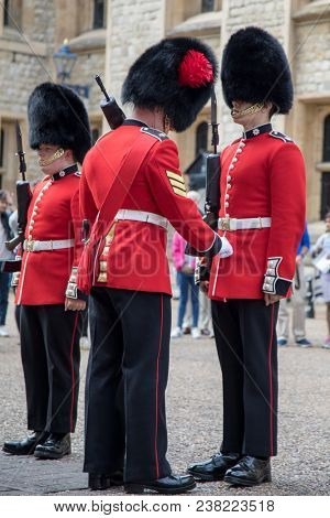 London, UK - 7th June 2017: The Queens Guard on parade at the Tower of London, in traditional red and black uniform with bearskin hats.