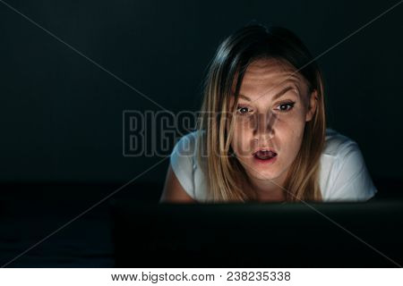 Image Of Young Employer Looking At Laptop With Surprise In Badroom. Woman Looking At Pc Screen Again