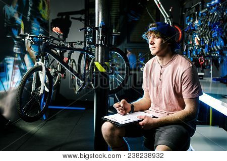 Young Handsome Stylish Man In A Cap Snapback And With A Tattoo Small Business Owner Selling A Bicycl