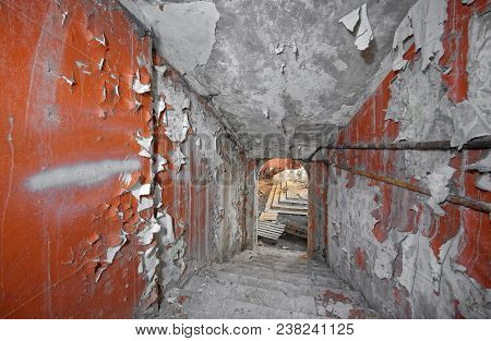 Descending Down The Concrete Staircase In An Abandoned Bomb Shelter With A Fading Paint And Scuffed 