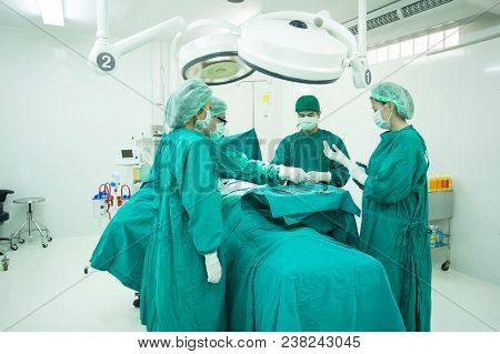 The Surgery Team Working Together At The Operating Room In The Hospital.