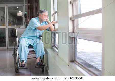 Asian Old Man Sit On Wheelchair Looking Out To Other Place. People With Health Care And Medical Conc