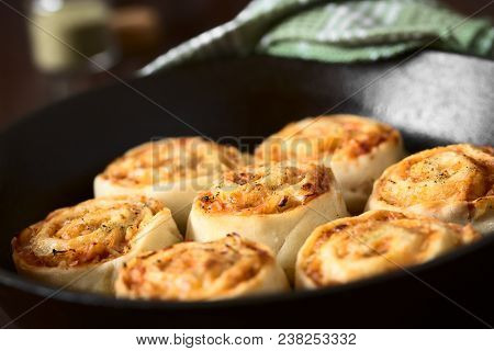 Homemade Pizza Rolls Or Pinwheels Filled With Ham, Onion, Tomato Sauce And Cheese, Photographed With
