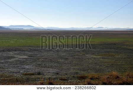 Empty Lake George Nestled Between A Rural Wind Farm And Farmland In Australia. Lake George Is An End