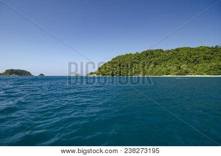 Scenic Sea View Of The Kapas Island At Terengganu, Malaysia. Clear Sea Water And Blue Sky Background
