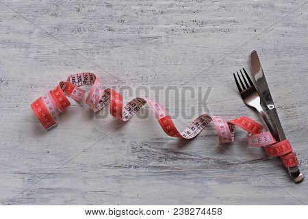 Dietary Recipe Dishes For Lunch, Measuring Tape And Fork And Knife At White Wooden Background/ Conce