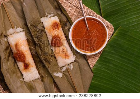 Top View Of Open Sticky Rice Wrapped In Leaves And Served With Peanut Sauce. Famous Cuisine In Borne