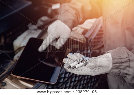 Close-up Of Auto Mechanic Diagnoses Car Using Tablet Computer. Service Center