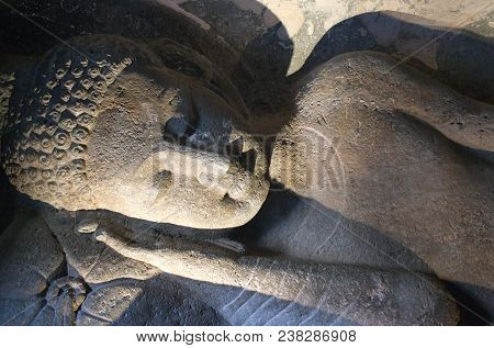 Ancient Stone Relief Of Lying Buddha In Ajanta Caves, India. The Ajanta Caves In Maharashtra State A