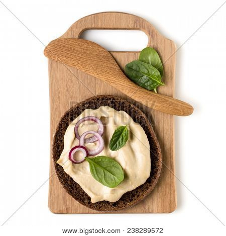 Open  faced hummus sandwich canape or crostini on a wooden serving board  isolated on white background closeup. Top view. Vegetarian tartarine.