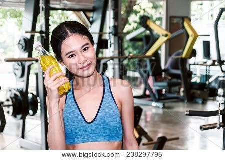 Sporty Woman Holdind Energy Drink Bottle At The Gym.fitness And Lifestyle Concept