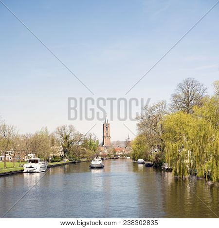 Loenen, Netherlands, 18 April 2018: Boats And Church Tower In River Vecht Near Loenen In Dutch Provi