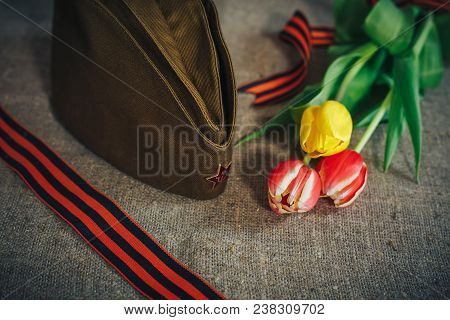 Military Cap With Order Of Great Patriotic War And Tulips Flowers Tied By Saint George Ribbon In Hon