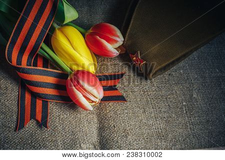 Military Cap With Order Of Great Patriotic War And Tulips Flowers Tied By Saint George Ribbon In Hon