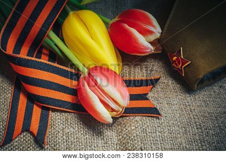 Military Cap With Order Of Great Patriotic War And Tulips Flowers Tied By Saint George Ribbon In Hon