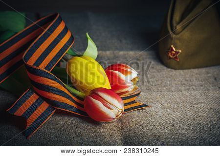 Military Cap With Order Of Great Patriotic War And Tulips Flowers Tied By Saint George Ribbon In Hon