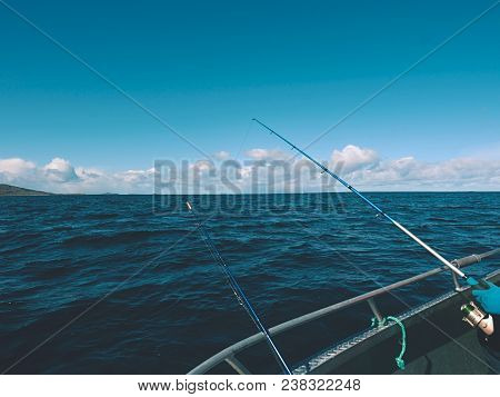 Sea Fishing From Steel Fishing Boat On Open Water. Rocky Island Et Horizon. Cold Sunny Day On Sea