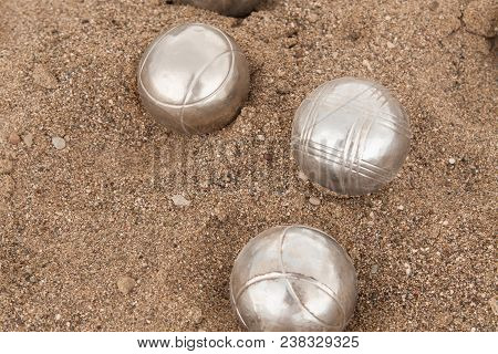 Beach. A Game Of Bocha. Brilliant Silver Balls For A Bocha On The Sand.