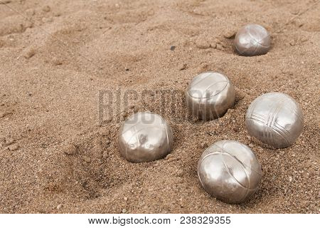 Beach. A Game Of Bocha. Brilliant Silver Balls For A Bocha On The Sand.
