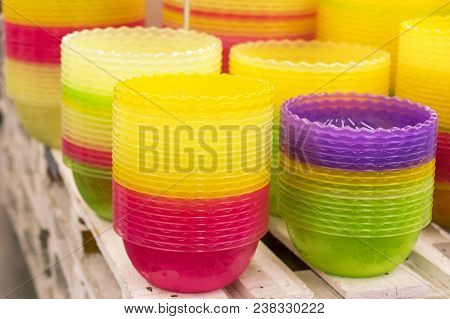 Plastic Multi-colored Bowls On The Shelf In The Store.