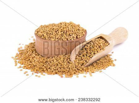 Fenugreek Seeds In Wooden Spoon, Isolated On White Background.