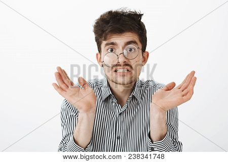 Messy Untidy Funny Guy With Moustache And Beard, Shrugging And Raising Palm, Grimacing From Confusio
