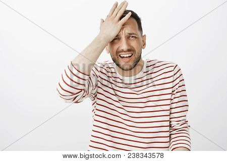 Crap I Forgot About Meeting. Portrait Of Embarrassed Handsome Troubled Guy In Striped Pullover, Punc