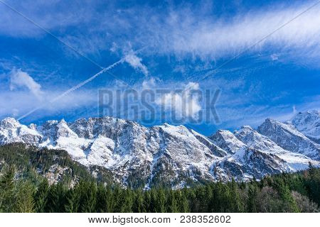 View to the Great snowcapped Mountains of the Bavarian Alps in Germany.
Close-up of the beautiful white Mountains and green Trees of the bavarian Alps on a sunny Day.
Mountain ans Nature Backgrounds.
