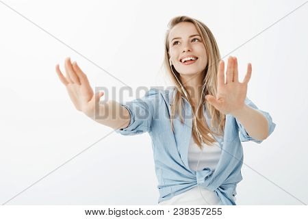 Joyful Happy Caucasian Girlfriend With Fair Hair, Pulling Hands Towards Camera As If Walking In Dark