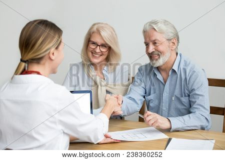 Smiling Senior Couple And Realtor Handshaking Making Real Estate Deal, Older Man And Mortgage Broker