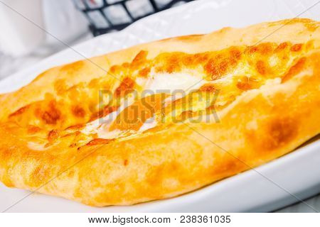 Ajarian Khachapuri With Yolk On White Plate