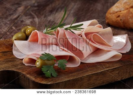 Sliced Ham On Wooden Background. Fresh Prosciutto. Pork Ham Sliced