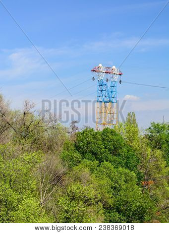 High Voltage Power Line. Great Height Above The Trees. Spring Sky. Copy Space.