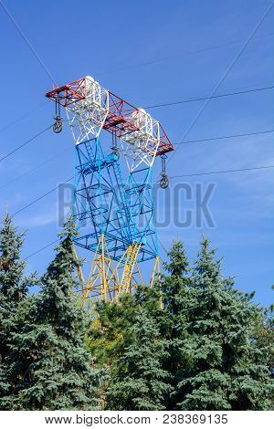 High Voltage Power Line. Great Height Above The Trees. Spring Sky. Copy Space.