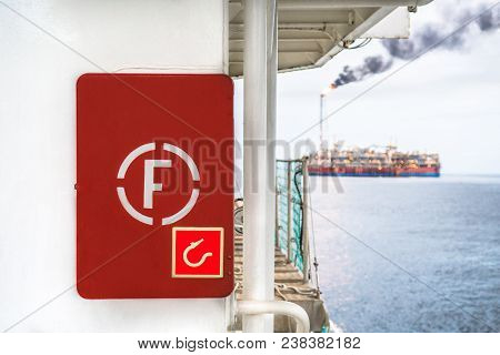 Fire Prevention Onboard Vessel At Sea. Fire Cabinet With Fire Equipment And International Fire Sign.
