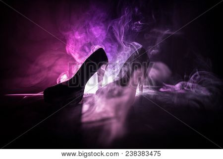 Black Suede High Heel Women Shoes On Dark Toned Foggy Background. Close Up. Women Power Or Women Dom