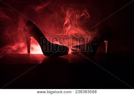 Black Suede High Heel Women Shoes On Dark Toned Foggy Background. Close Up. Women Power Or Women Dom