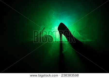 Black Suede High Heel Women Shoes On Dark Toned Foggy Background. Close Up. Women Power Or Women Dom