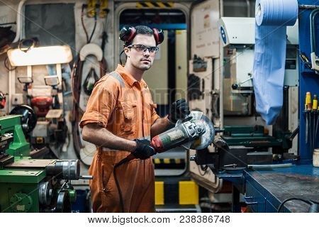 Marine Engineer Working In Ship's Workshop In Engine Control Room