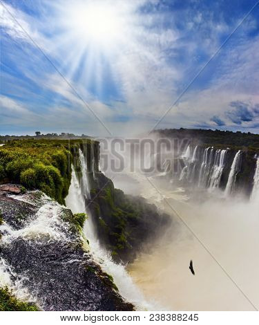 Parana River. Devil's Throat /Garganta del Diablo/ is the grandiose part of the Iguazu Falls. The autumn sun shines through the clouds. Concept of active and extreme tourism 