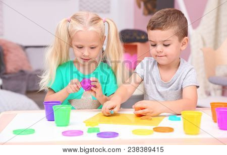 Cute little children modeling from playdough at home