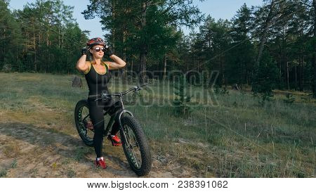 Fat Bike Also Called Fatbike Or Fat-tire Bike In Summer Riding In The Forest. Beautiful Girl And Her
