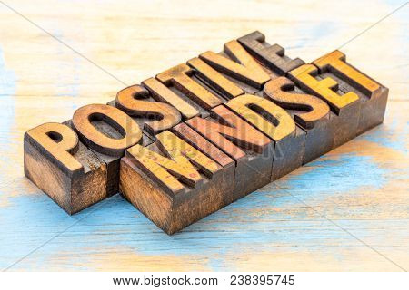 positive mindset - word abstract in vintage letterpress wood type stained by color inks